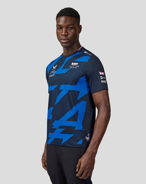 Male model wearing navy BWT Alpine Formula One Team driver jersey with bold blue geometric pattern and sponsor logos.