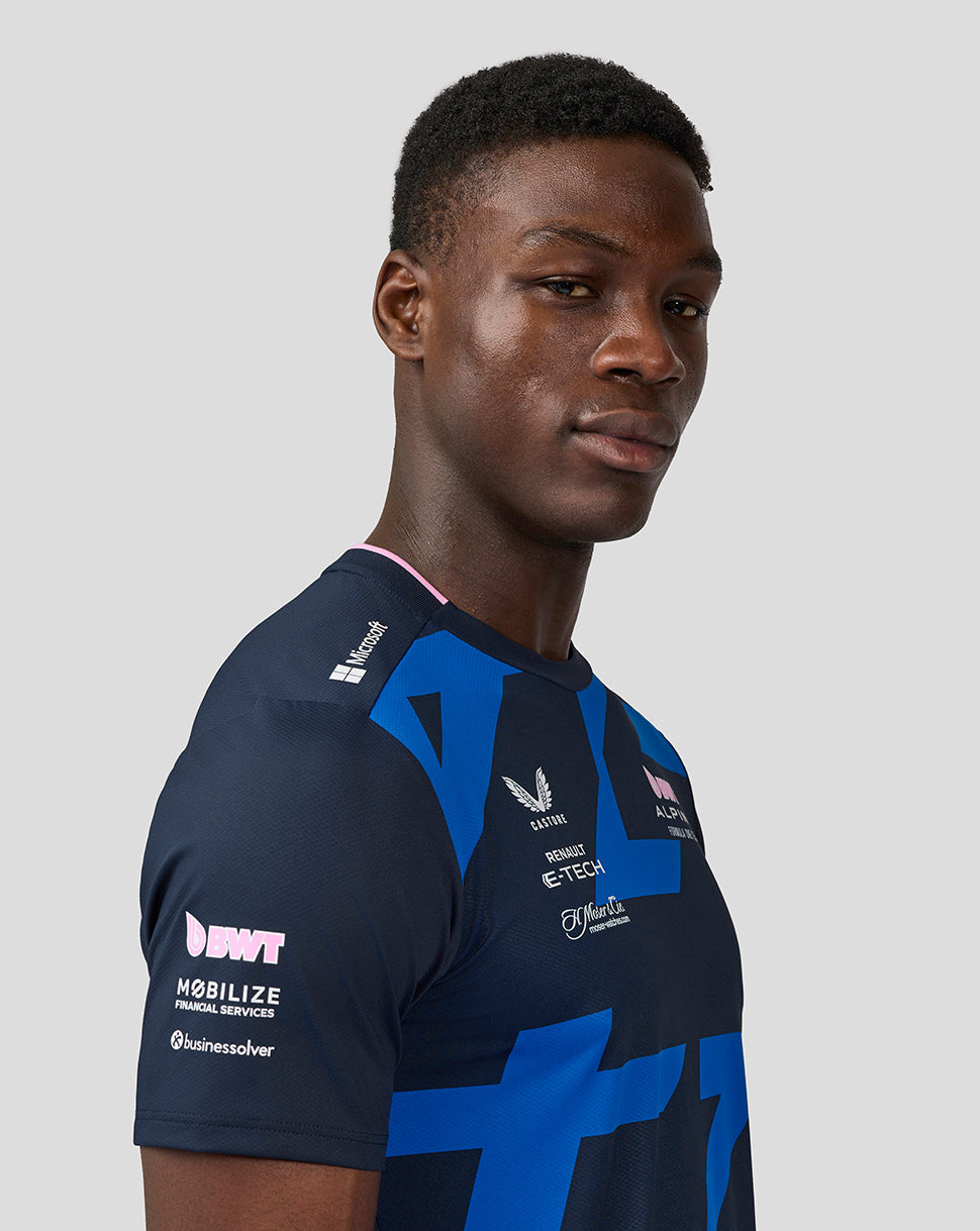 Male model wearing navy BWT Alpine Formula One Team Jack Doohan jersey with bold blue geometric print.