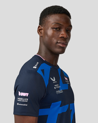 Male model wearing navy BWT Alpine Formula One Team Jack Doohan jersey with bold blue geometric print.