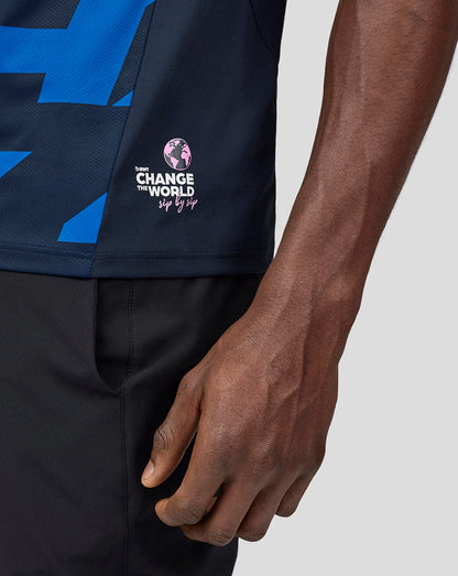 Side view of a male model in a navy Alpine Jack Doohan jersey featuring blue geometric print and sponsor logos.