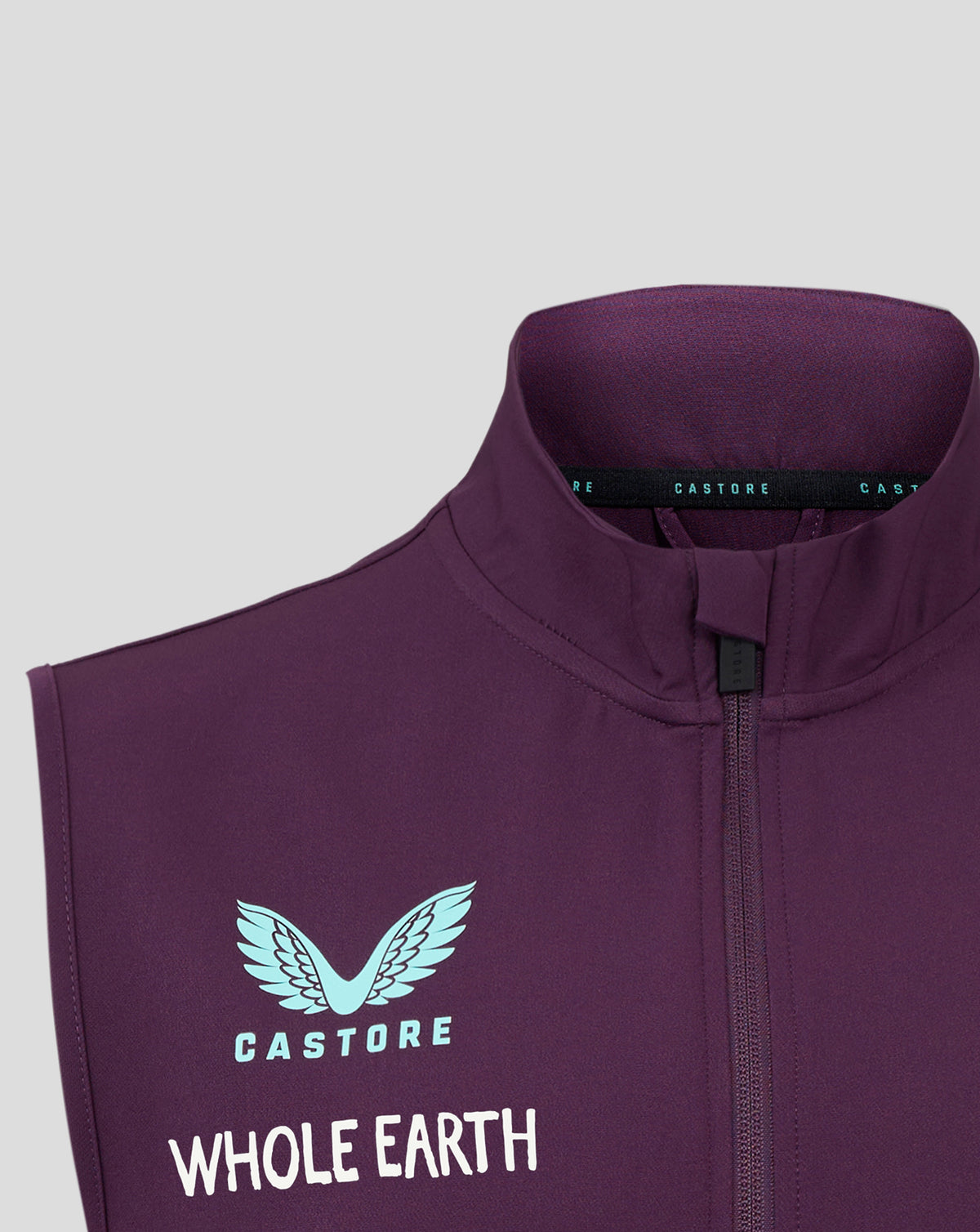 Close-up of the neck area showing a blue inner collar and CASTORE branding on the plum training gilet
