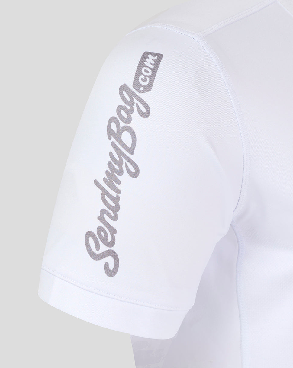 White rugby jersey sleeve with large Kingspan branding running along the upper arm