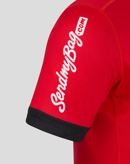 Close up of red away Pro shirt sleeve with white vertical sponsor text and black cuff