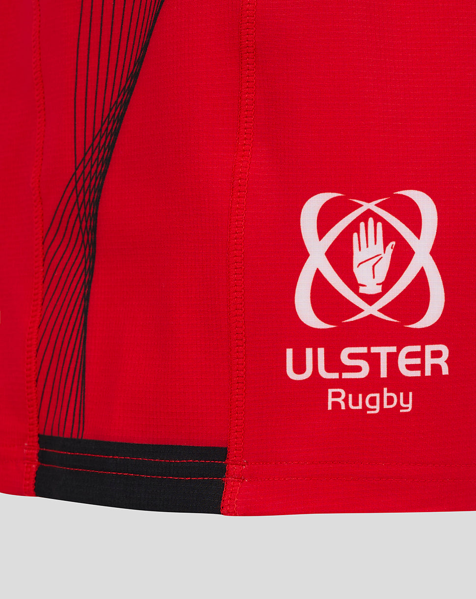 Close-up of red Ulster Rugby Pro Shorts fabric with white logo and visible stitching details.