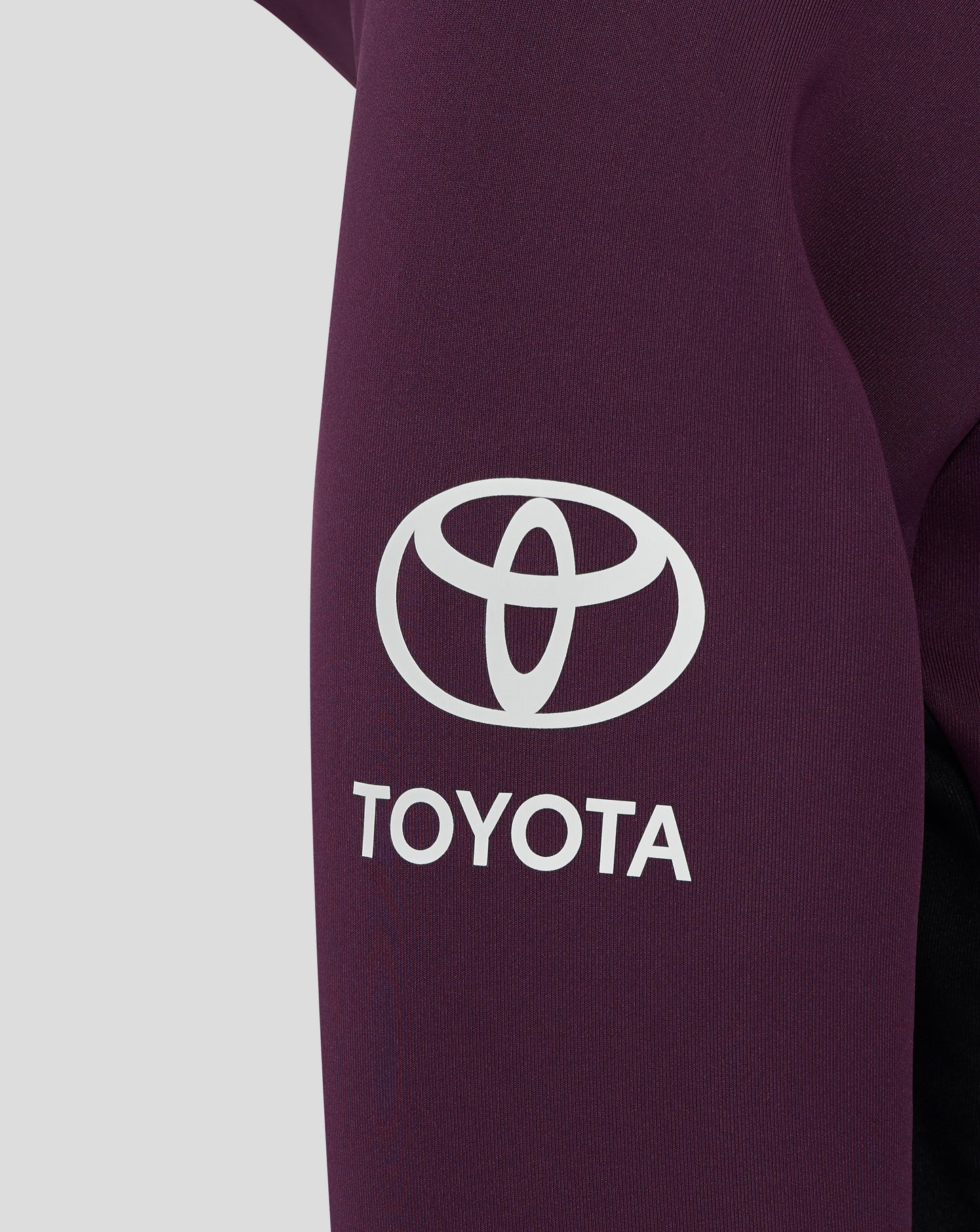 Close up of the chest area on the maroon England hoodie showing a white Toyota logo