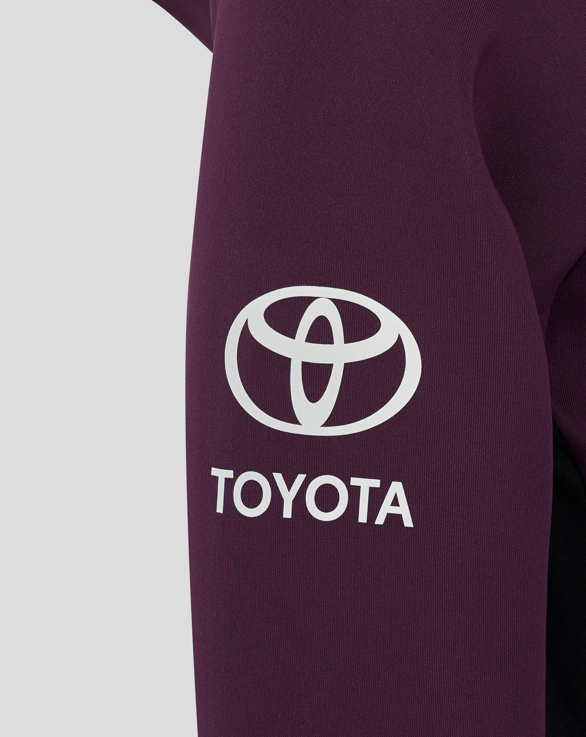 Close up of the chest area on the maroon England hoodie showing a white Toyota logo