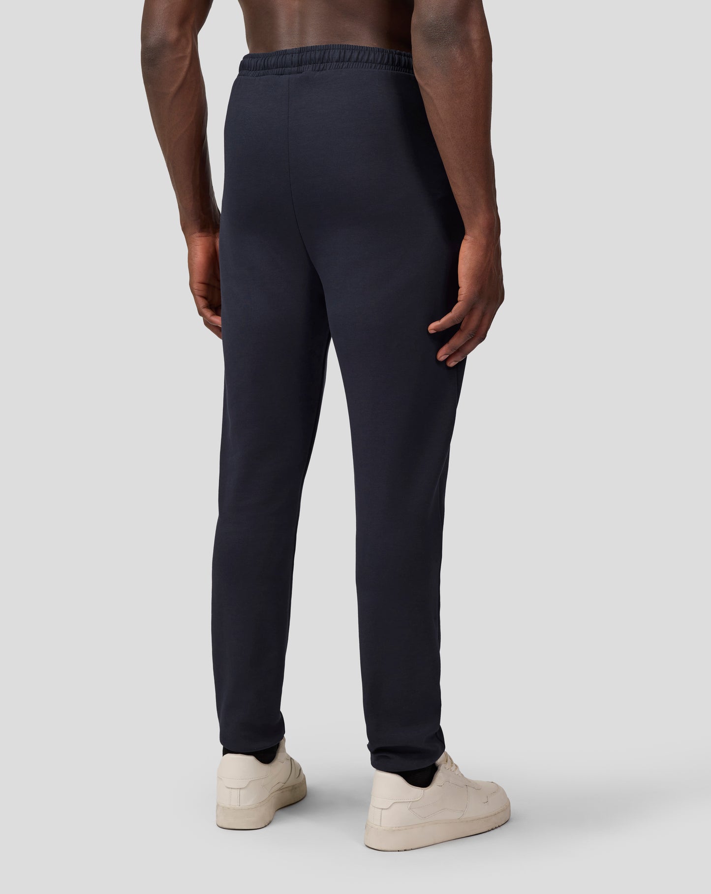 Back view of navy Oracle Red Bull Racing joggers with elastic waistband and winged logo on the lower leg.