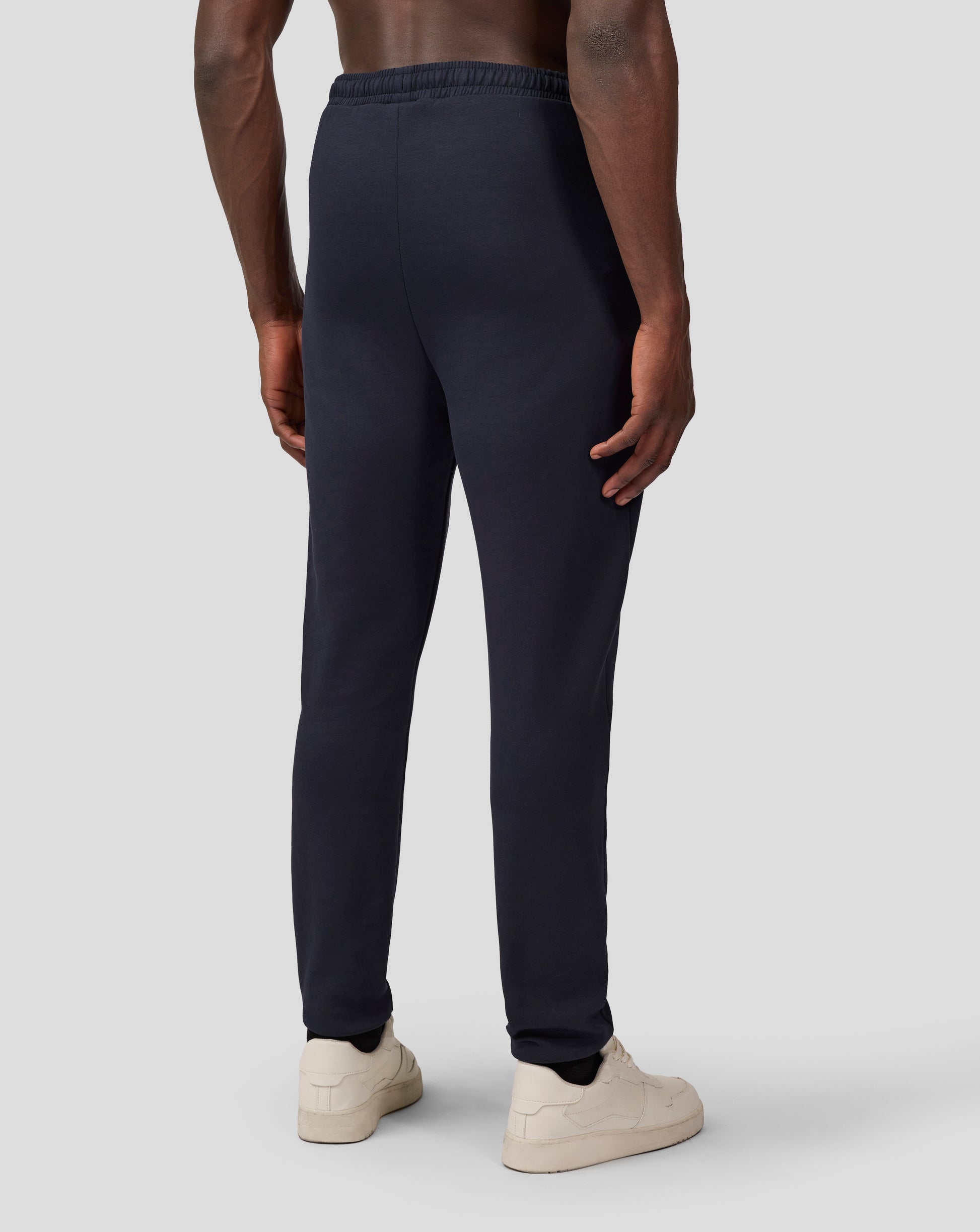 Back view of navy Oracle Red Bull Racing joggers with elastic waistband and winged logo on the lower leg.