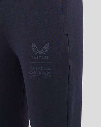 Close-up of navy jogger leg showing large Castore branding and Oracle Red Bull Racing logo.