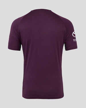 Purple t-shirt with a logo on the sleeve against a gray background