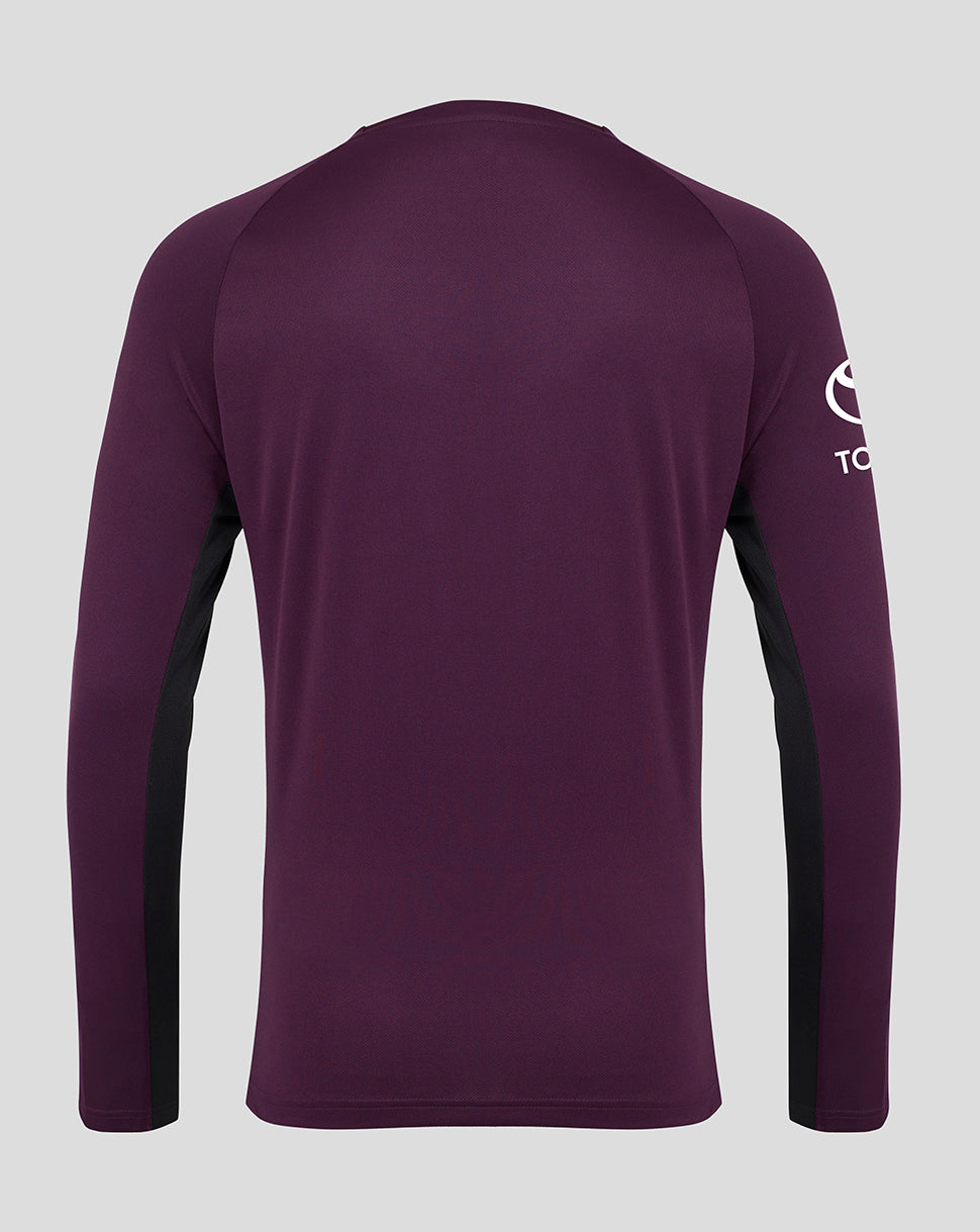 Purple long-sleeve shirt with a logo on the sleeve against a gray background