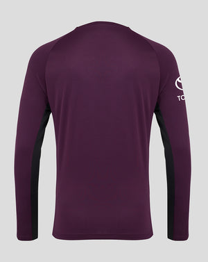Purple long-sleeve shirt with a logo on the sleeve against a gray background