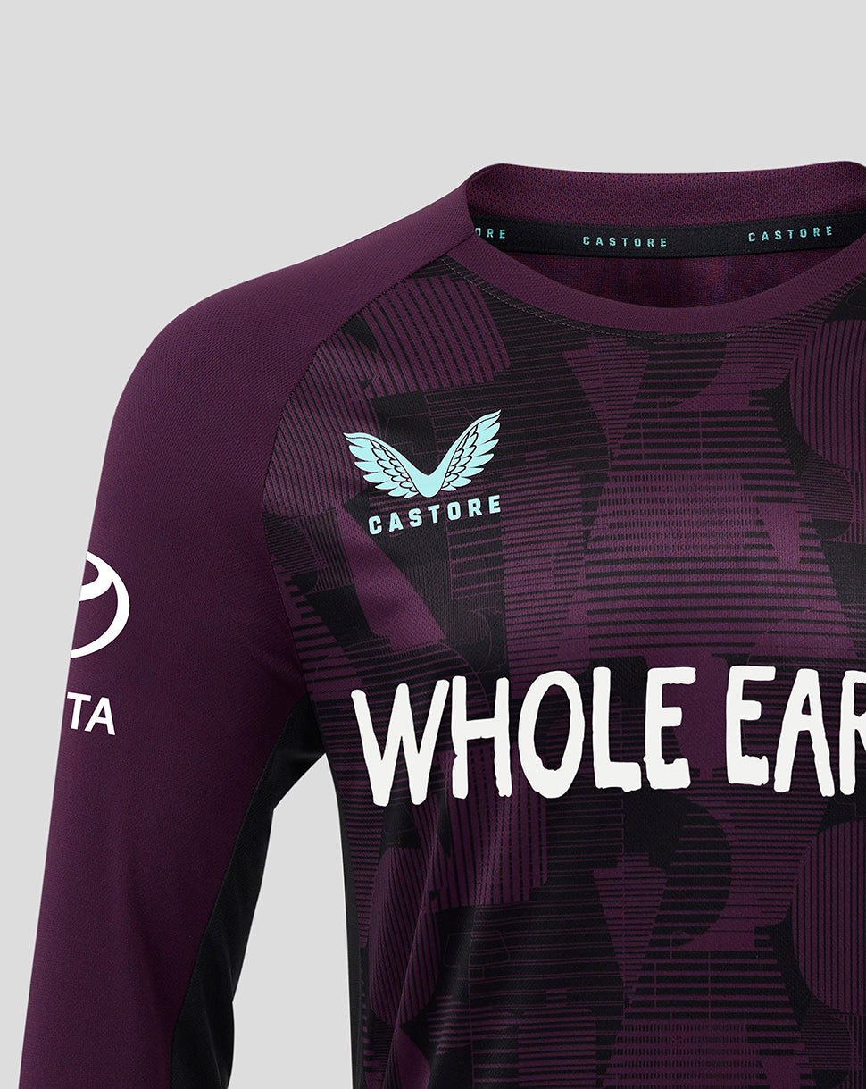 Purple athletic shirt with 'Castore' branding and text on a light gray background