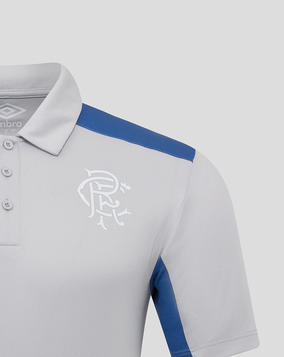 Close-up of Rangers polo collar and shoulder with blue stripe and white club crest on chest.