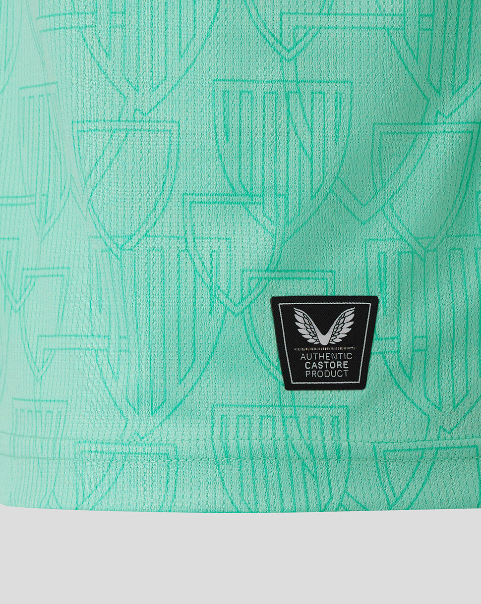 Close-up of back hem on turquoise Athletic Club Third Shirt showing authentic Castore product patch