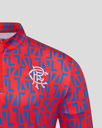 Rangers away matchday zip top in red and blue geometric pattern with crest on chest.