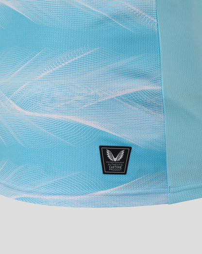 Close up of Burnley FC 25/26 away shirt fabric in light blue with a black authenticity patch featuring wings.