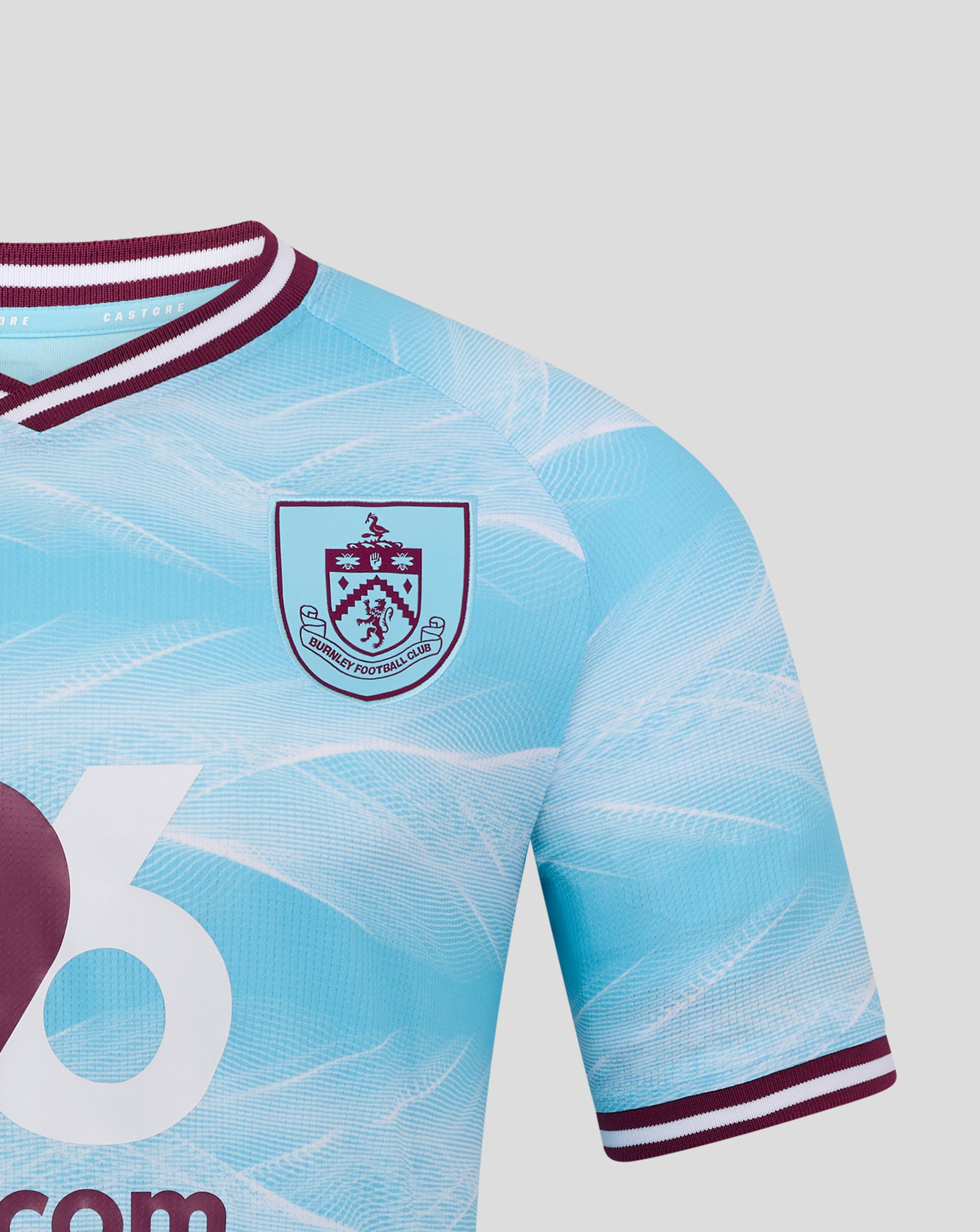 Close up of the neck and crest on the Burnley FC away shirt in light blue