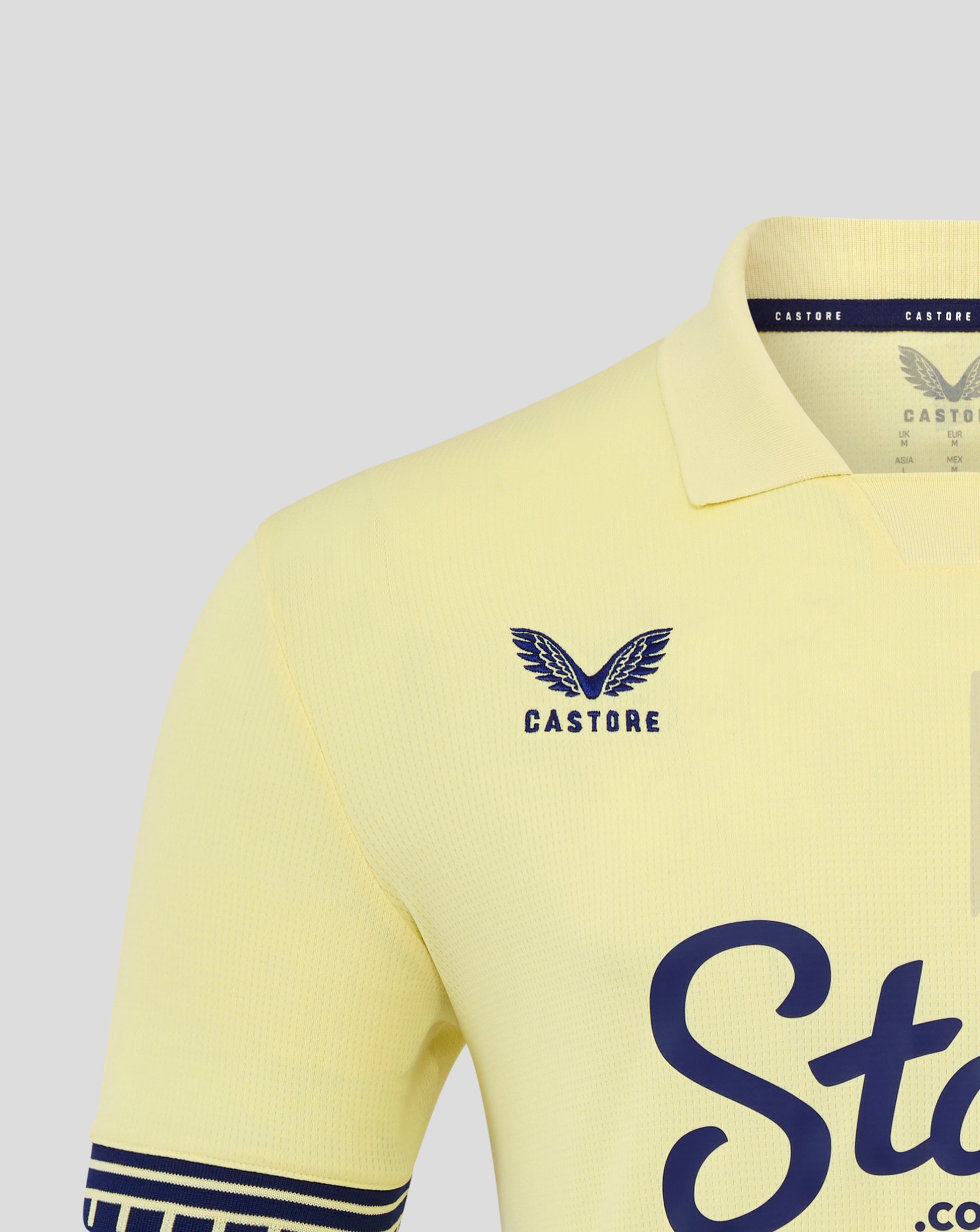 Everton 25/26 away shirt in pale yellow shown from the front with navy crest on the left chest and large blue Stake.com script across the front.