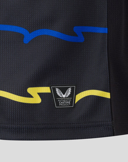 Close-up of Everton 25/26 Junior Third Shirt fabric with blue wave graphic and authentic Castore patch.