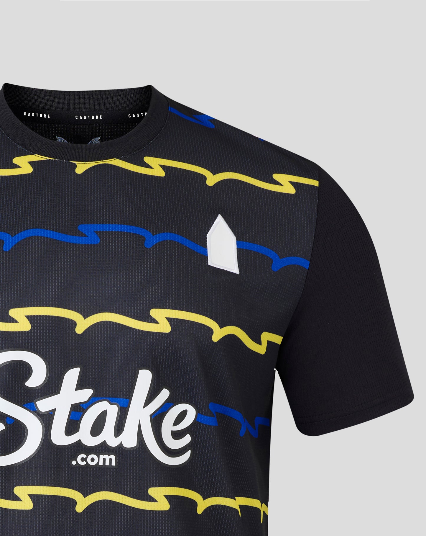 Close up of Everton 25/26 Men's Third Shirt showing bright yellow graphic across the chest on navy fabric with a white logo detail.