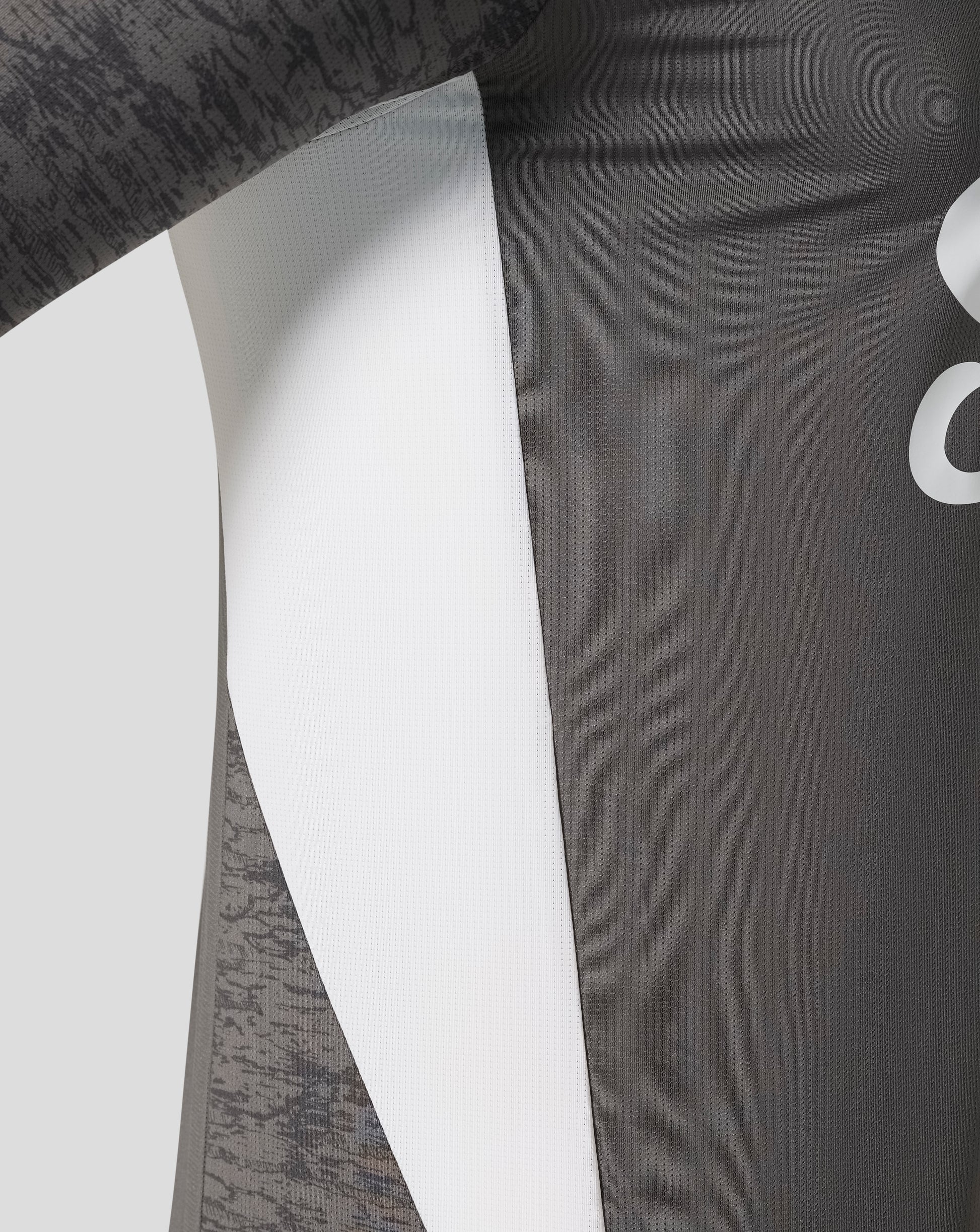 Close up of the shirt fabric showing white center panel and dark gray panels with subtle vertical texture