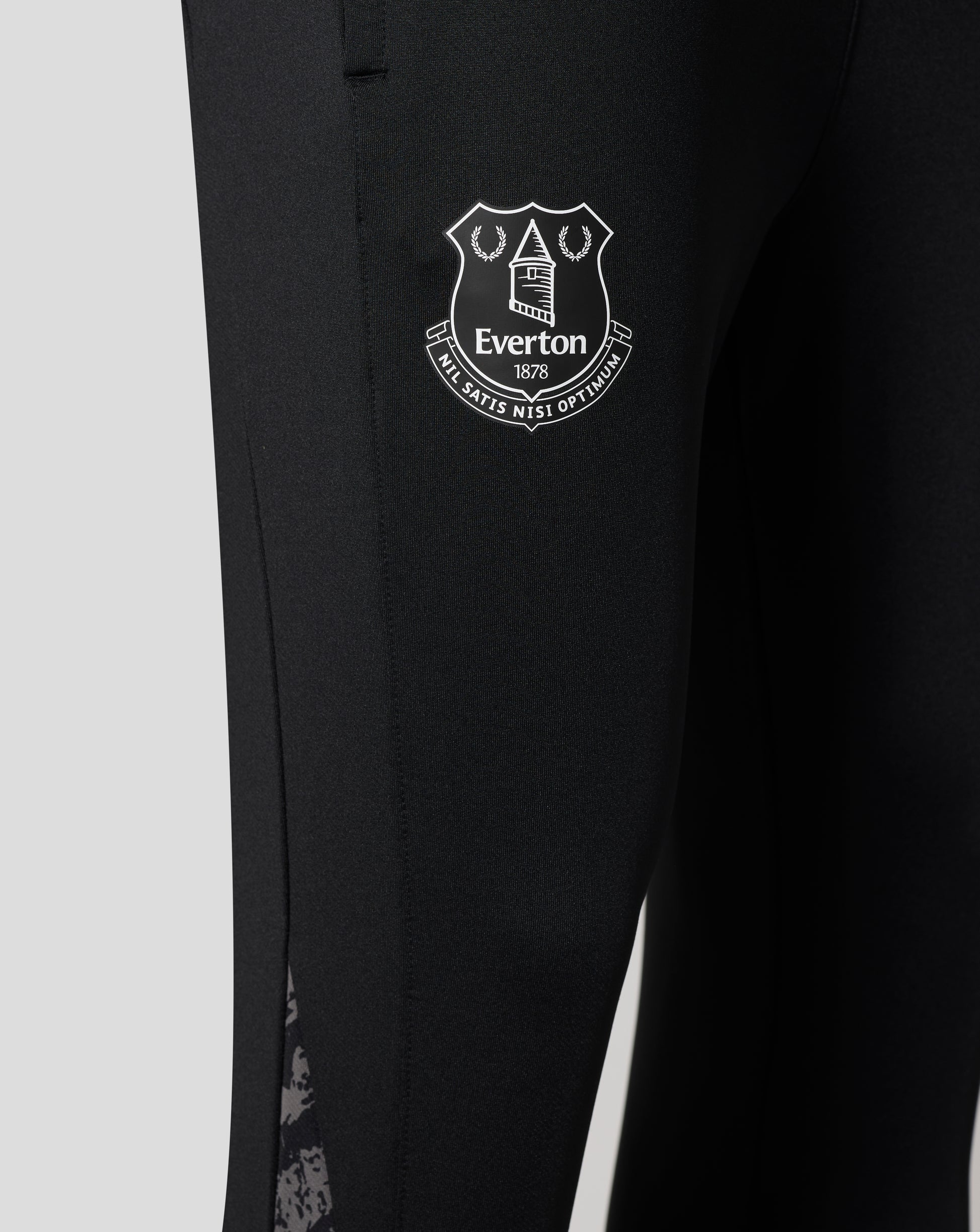 Close up of the Everton crest badge on the black performance knit pants leg