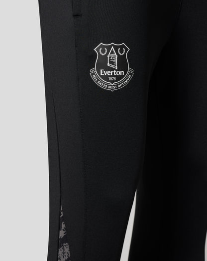 Close up of the Everton crest badge on the black performance knit pants leg