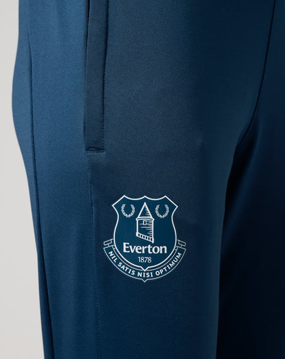 Close up of the blue textured knit fabric with a partial Everton crest emblem visible.