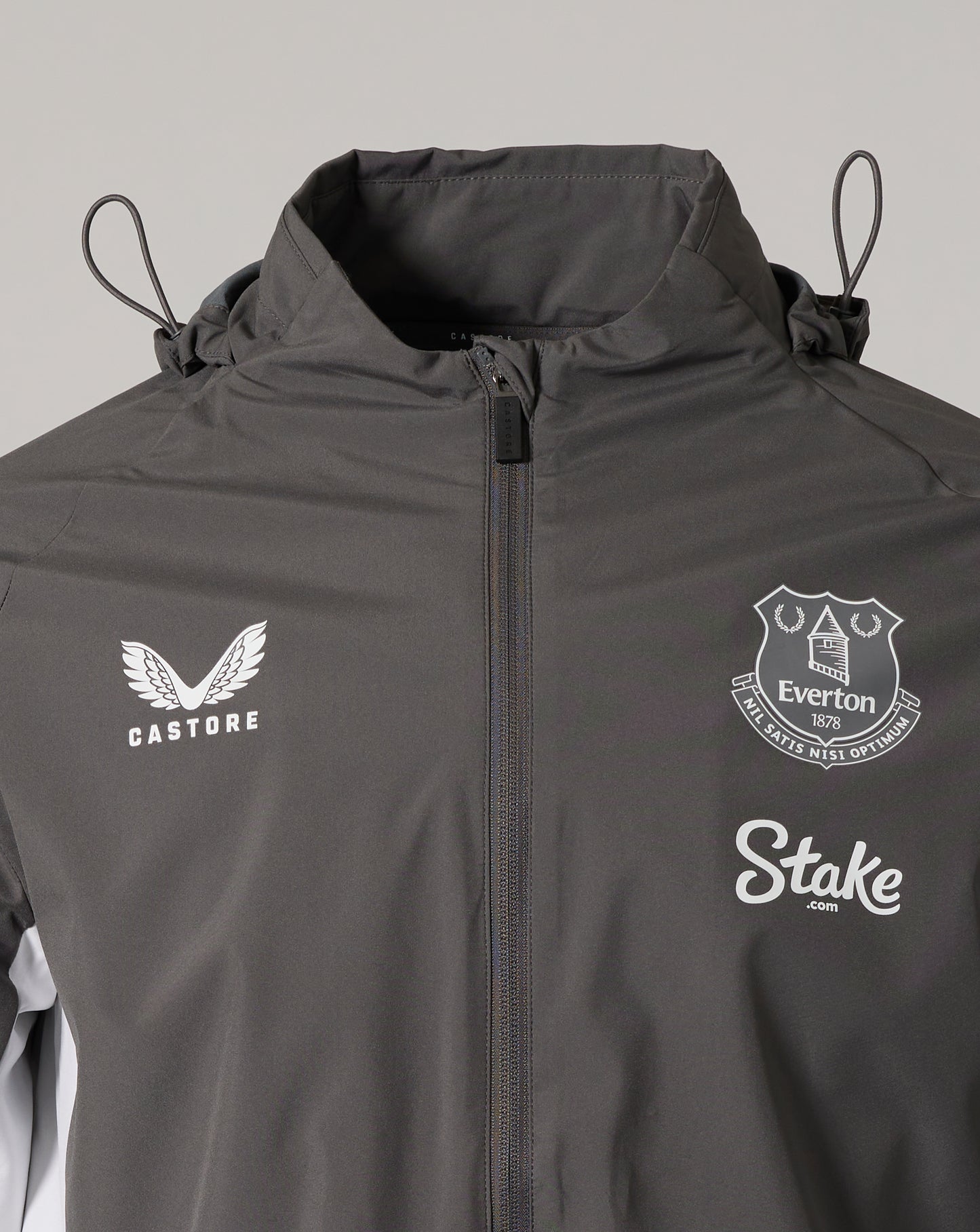 Close up of the chest area with Castore logo on the left, Everton crest on the right, and Stake logo visible on the front.