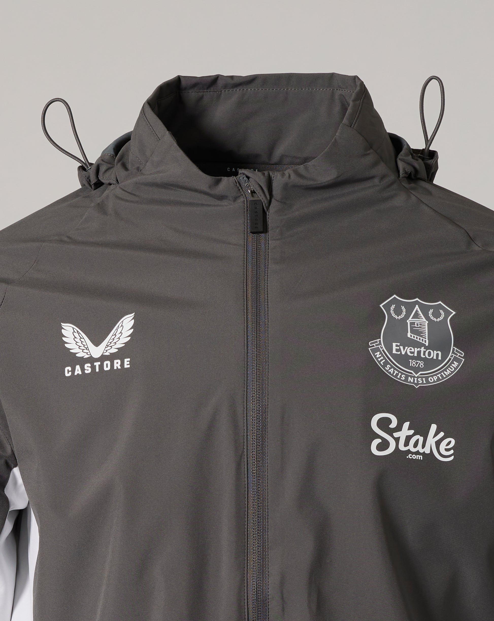 Close up of the chest area with Castore logo on the left, Everton crest on the right, and Stake logo visible on the front.