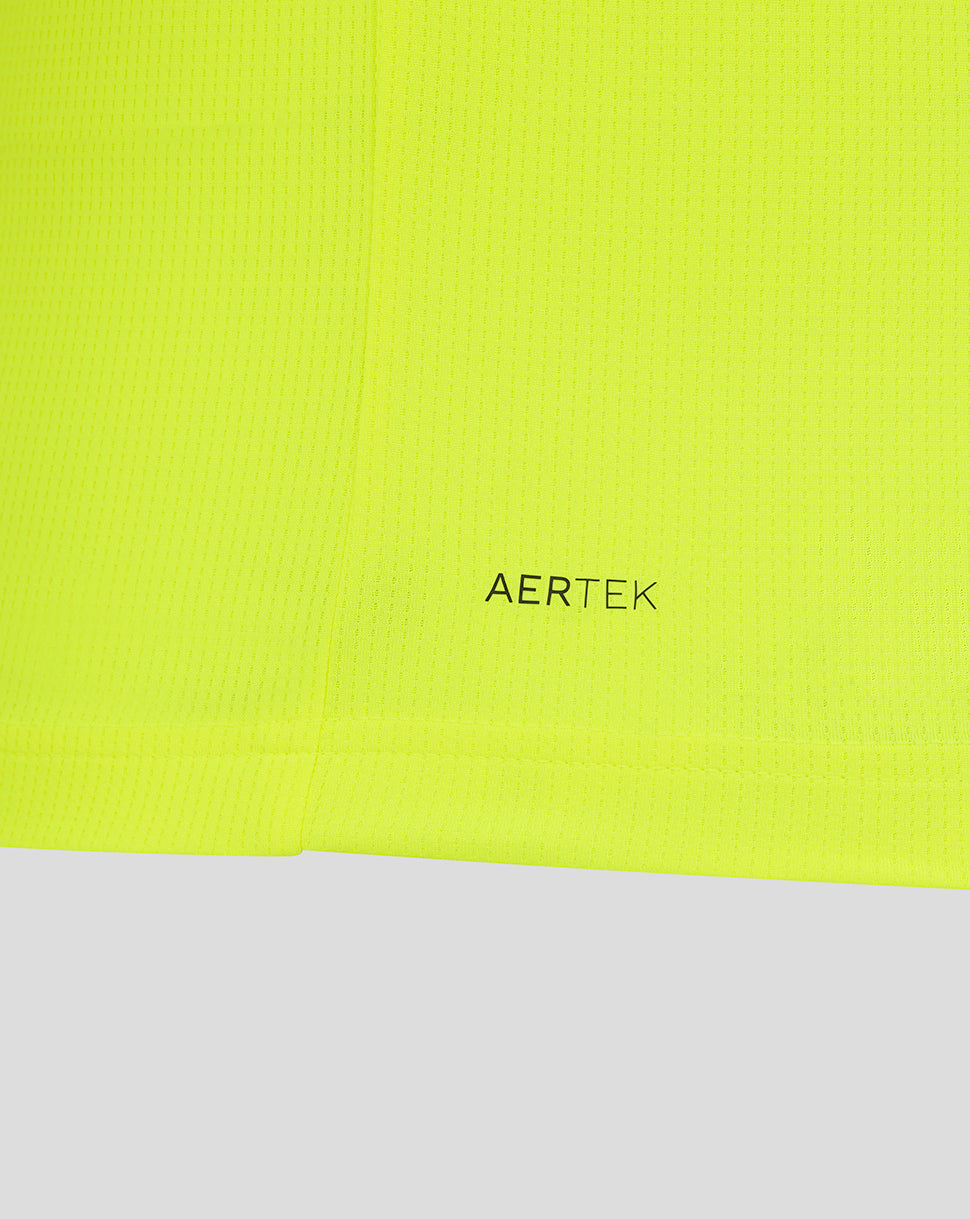 Detail of neon yellow fabric with AERTEK branding near the hem and blue sleeve edge.