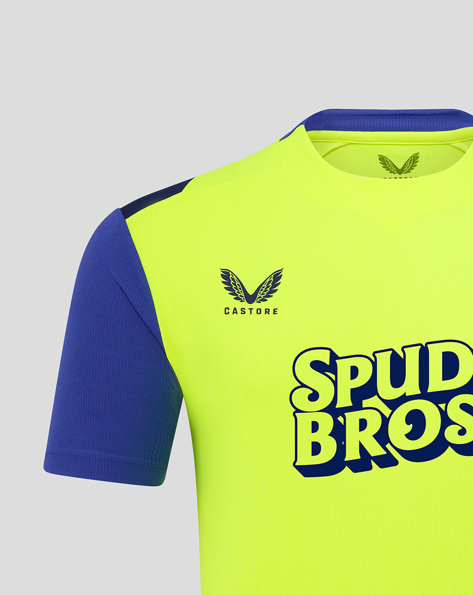 Close up of neon Preston shirt showing CASTORE logo on the chest and bold SPUD BROS lettering across.