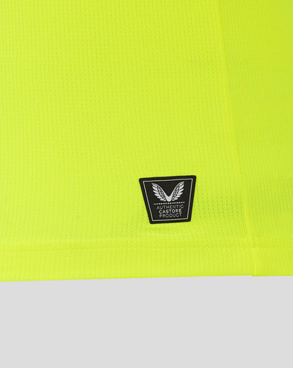 Neon yellow fabric close-up with authentic Castore product badge on the lower front of the Preston North End replica shirt.