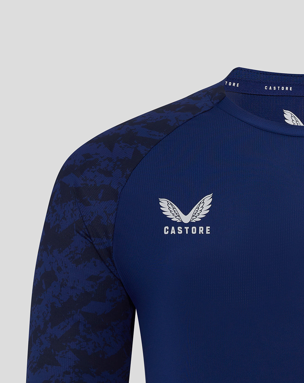 Close-up of shoulder and collar showing Castore branding and partial club crest on the blue Preston training T-shirt