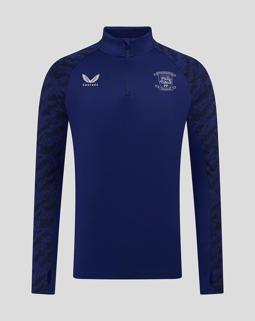 Front view of Preston Junior blue training midlayer with camo sleeves and Castore logo on the right chest.