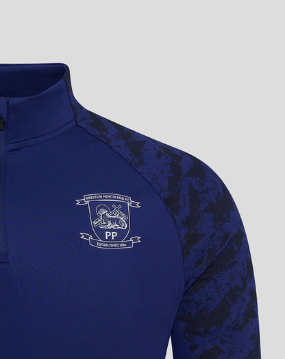 Blue Preston 25/26 training midlayer top chest area with club crest and Castore logo