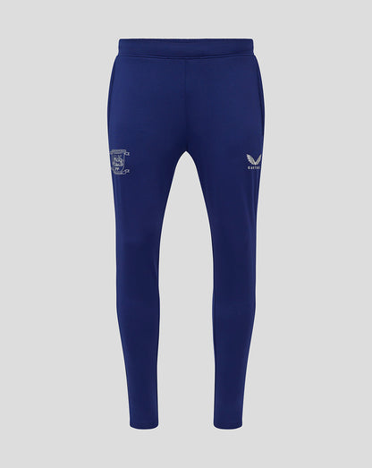 Blue Preston training knit pants with elastic waistband and pockets featuring crest on the left leg and Castore logo on the right