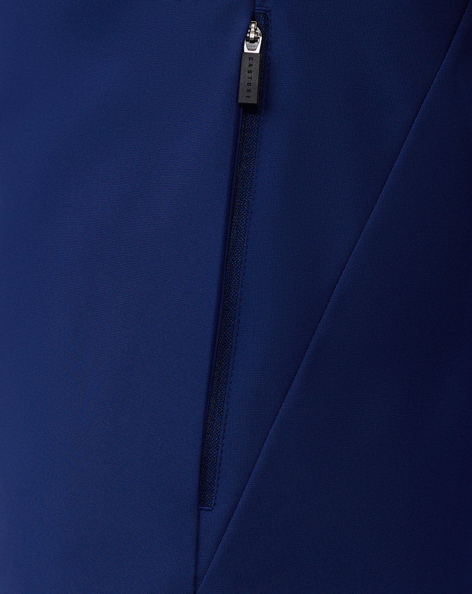 Close-up of blue jacket zipper with Castore pull and fabric detail.