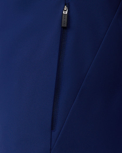 Close-up of blue jacket zipper with Castore pull and fabric detail.