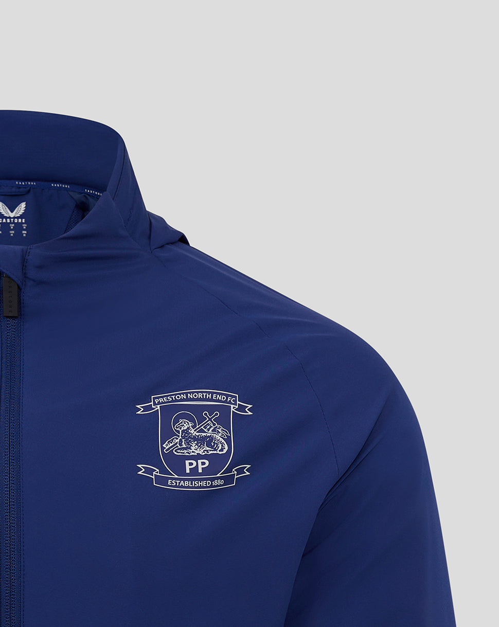 Front view of blue Preston North End training jacket showing club crest