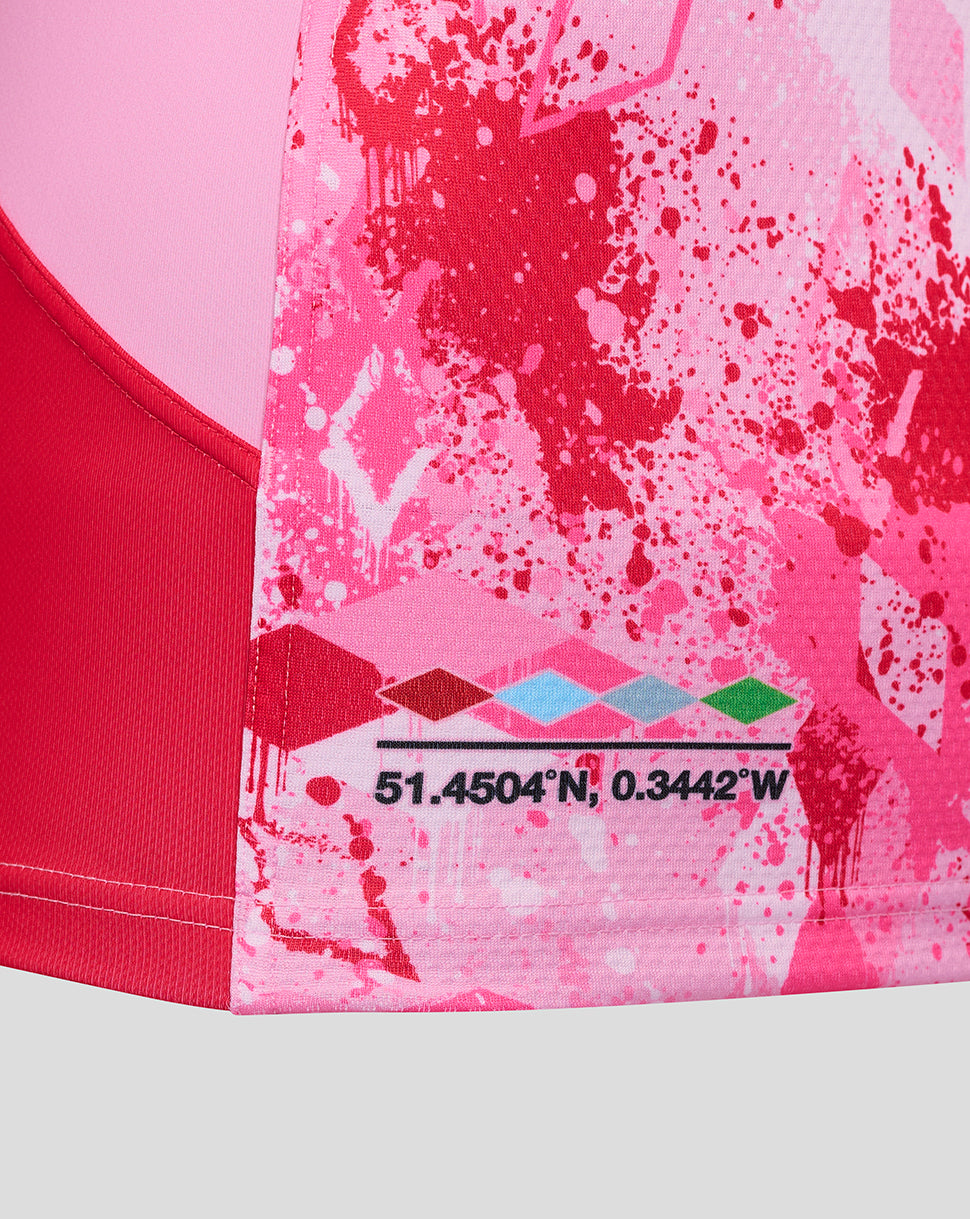 Lower portion of the pink Harlequins away pro shirt with coordinates and a colorful diamond motif at the hem.