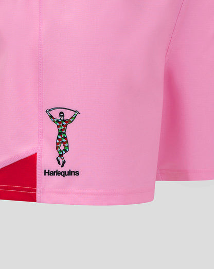 Close-up of pink Harlequins shorts showing a stitched Harlequins emblem on the left leg