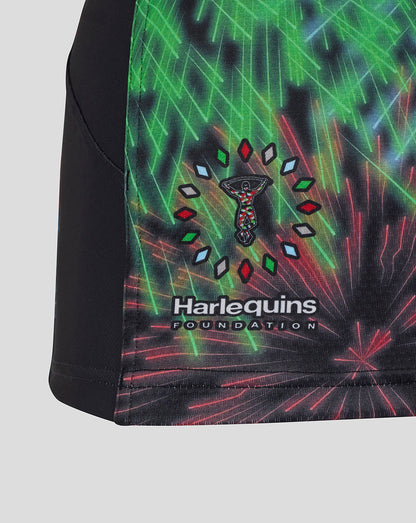 Side view of Harlequins Pro Shirt with foundation logo patch near hem and fireworks graphic on black fabric with green trim