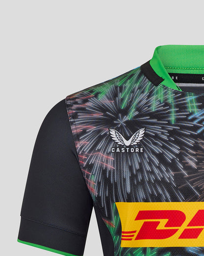 Close up of Harlequins Pro Shirt shoulder area showing the Castore logo and Harlequins crest on a fireworks pattern.