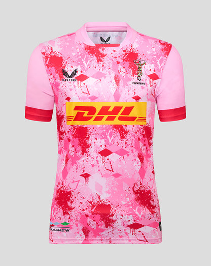 Front view of pink Harlequins away replica shirt with red splatter pattern and DHL sponsor across the chest; Harlequins crest and Castore logo visible.