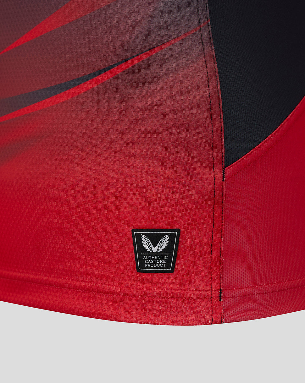 Close-up of red Saracens Pro Home Shirt fabric at the hem with an authentic Castore badge
