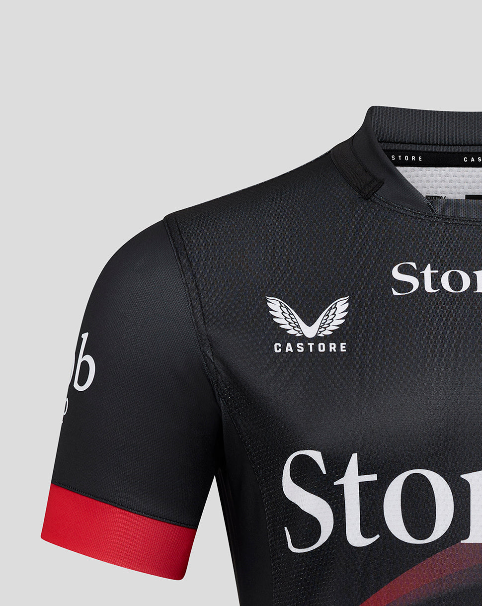 Front upper torso view of Saracens Pro Home Shirt displaying Castore logo and wing emblem on dark fabric with red sleeve cuff