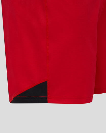 Close-up of red Saracens shorts showing the curved hem and black underlayer detail.