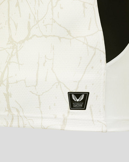 Close-up of the Saracens Pro Away Shirt fabric with a beige pattern and Castore authenticity badge.
